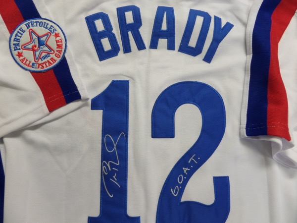 Why a Brady signed Expos jersey?  I actually had to look that one up myself.  He was actually selected by the team in the 18th round of the 1995 MLB draft.  Who knew?  So that's why we have this white size L Expos throwback jersey from Mitchell & Ness is back number-signed in silver by the future Hall of Fame NFL star, complete with a G.O.A.T. inscription.  A great looking jersey, and an unique collector's item, and retail is ???