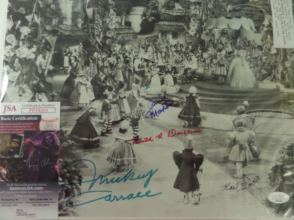 This 1939 MGM classic image is 11x14 in size, and shows Dorothy on her travels down the Yellow Brick Road. It is a classic Hollywood movie and moment, comes sharpie signed by FOUR of the original kid Munchkins who appeared, and grades a perfect 10 all over. I see signatures from Mickey Carroll, Karl Slover, Jerry Marren and Ruth Duccini. It has a lifetime COA included from JSA, and value in the large size is mid to upper hundreds. 