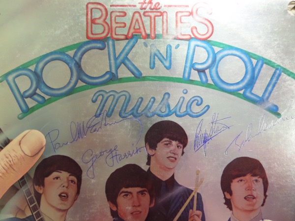 This vintage LP is "Rock n' Roll Music" and is in about fine+ overall condition. It shows all 4 rock stars and HOF Legends on the color cover, and comes blue ink signed by John, George, Ringo and Paul. The signatures are clear and legible, honest 8's or better overall, and value is thousands on this must have musical investment. 