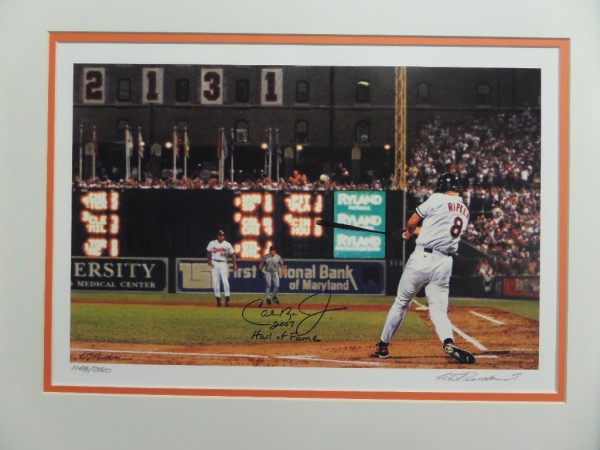 This high quality work is easy on the eyes, done in lots of team black and orange colors, and shows Cal at bat and in mid-swing. It comes IN PERSON, perfectly blue marker signed, HOF Induction year added, and has our own famous lifetime guarantee attached. Get it JSA or PSA, we don't care..Full money back if it fails! It is matted to 16x20 in white and orange, and looks amazing from across our auction room. 