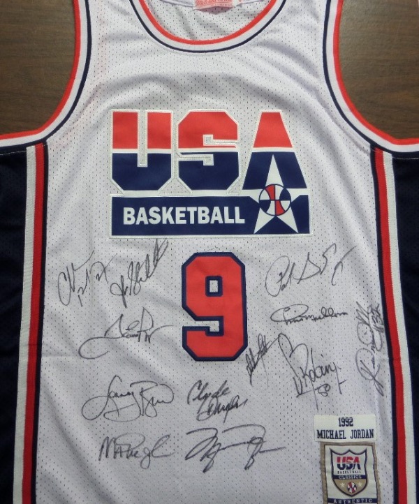 This white size 50 Mitchell & Ness #9 USA Basketball Michael Jordan jersey is in NM/MT condition, with everything sewn, and comes front signed in black sharpie by by all 12 members of the original Dream Team!  Included are Bird, Magic, Jordan, Barkley, Ewing, Drexler, Robinson, Malone, Stockton, Pippen, Laettner and Mullin, and this AWESOME and one of a kind display item books well into the low thousands!