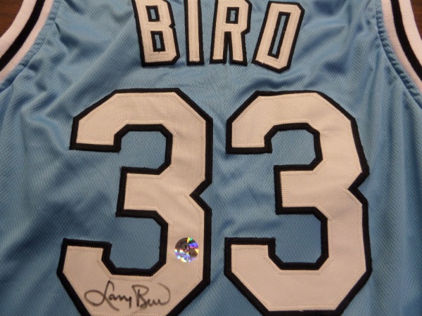 This superb road powder blue is a 1980's Indian State rare offering, comes trimmed in black and white school colors, and has sewn on everything as well as name on back. It comes back #33 signed by the toughie in bold black marker, has his own company's hologram for lifetime certainty, and investment in the Boston Legend is almost too easy. 