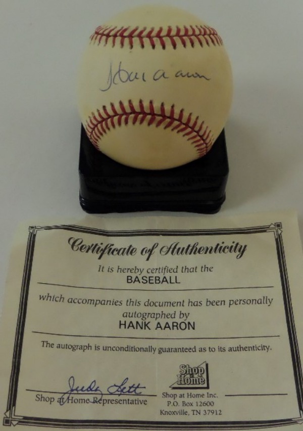 This Official National League Baseball (White) from Rawlings is still in VG+ shape, and comes hand-signed across the sweet spot in blue ink by baseball's true home run king, the great Hank Aaron.  The signature grades about an 8 overall, and the ball comes with a Shop at Home COA for rock solid authenticity.  Valued well into the hundreds!