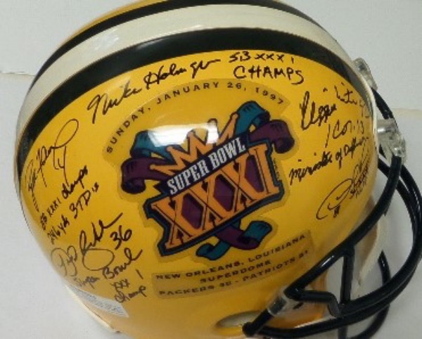 This full size replica Packers helmet from Riddell features the GB logo on one side, and the logo for Super Bowl XXXI on the other.  The SB logo side features black sharpie signatures from 5 key team members of the XXXI Champs, including Reggie White, MVP Desmond Howard, coach Mike Holmgren, and HOF'ers LeRoy Butler and Brett Favre, and each has added a fantastic inscription to his autograph.  This helmet is absolutely ESSENTIAL to any Packers collection, and retail is low thousands!