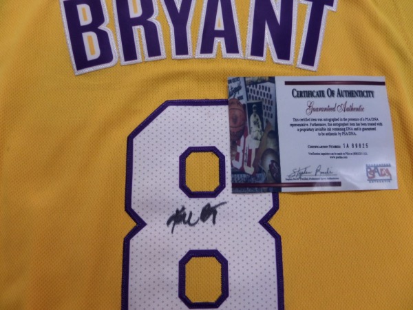 This mint home gold style is trimmed in the usual white and purple team colors, has sewn on everything as well as name on back, and comes full name back #8 signed by the LA HOF Great. It is signed in bold black sharpie, has a numbered lifetime PSA/DNA cert intact, but has NO hologram remaining on the actual jersey. Super investment, and value is thousands. 
1A69625