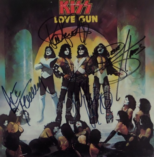 This wildly popular 1970's LP is "Love Gun" and shows all 4 original rock stars in makeup on the color cover. It comes hand signed by Gene, Paul, Ace and Peter in large, bold black marker, and value on this gem is about a grand. You will not find better, or more authentic!