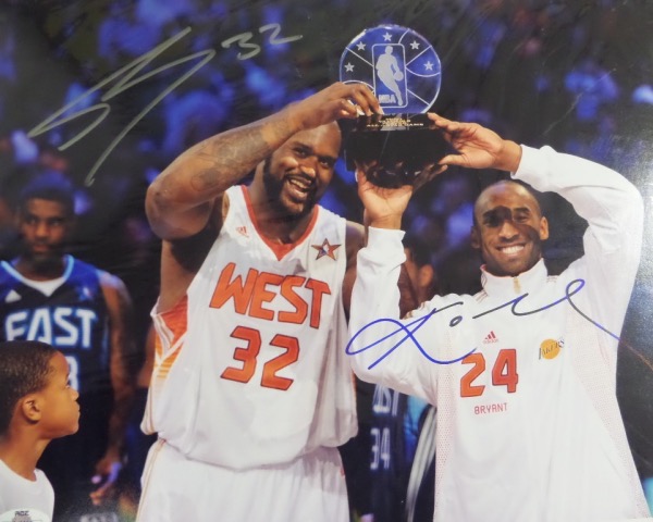 This full color 11x14 photo shows Kobe and Shaq holding an All Star MVP trophy between them.  It comes hand-signed by both, with Kobe in blue sharpie and Shaq in silver sharpie, and is MINT, and ready for your framing touch.  Valued well into the hundreds!