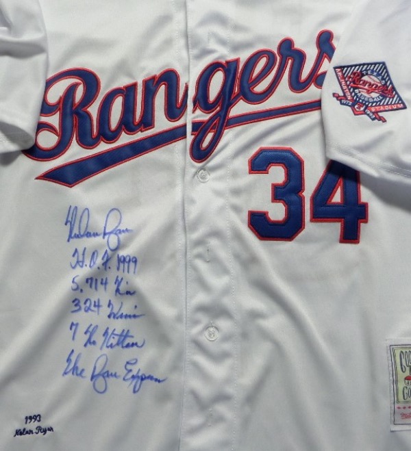 This home white Ryan #34 custom size L Texas Rangers 1993 throwback baseball jersey from Mitchell & Ness is like NEW, and comes with everything trimmed in blue and red, and hand-sewn.  It is front-signed in blue sharpie by the Strikeout King himself, grading an overall 8.5, with 7 No Hitters, 324 Wins, 5,714 K's, The Ryan Express and HOF '99 inscriptions.  A super cool and unique collector's item, ready for framing and display, and retail is high hundreds!