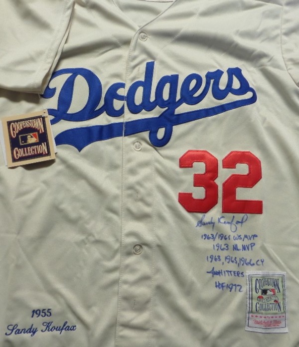 This size L cream-colored 1955 Brooklyn Dodgers custom throwback jersey is trimmed in red and blue with everything sewn on, and comes front signed in blue sharpie by the great 3 time Cy Young Award Winner and HOF lefty!  The signature grades a legible 8.5, includes 4 No Hitters, 1963, 1965, 1966 Cy, HOF 1972, 1963/1965 WS MVP and 1963 NL MVP inscriptions, and will show off brilliantly in any baseball collection!