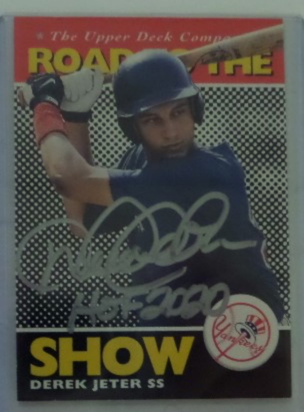 This 1994 Upper Deck "Road to the Show" #165 Derek Jeter rookie baseball card is in NM condition, and comes hand-signed in silver sharpie by the HOF shortstop himself.  The signature grades about an 8, including a HOF 2020 inscription, and retail is well into the hundreds!