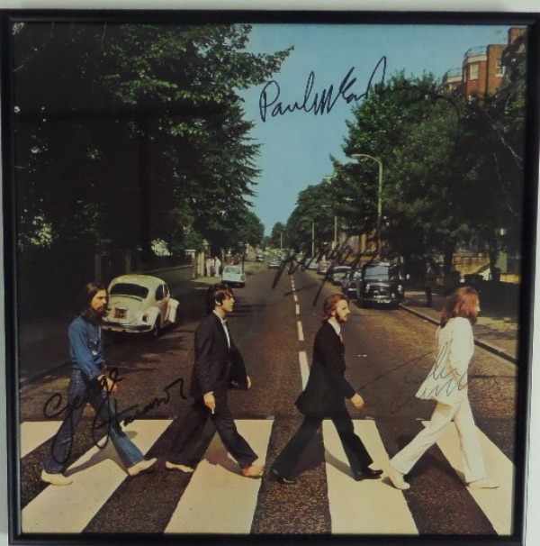 This color "Abbey Road" LP shows all 4 rock stars as they cross the street in England. It comes hand signed by Ringo, Paul, George and John nicely on the color cover, and comes framed in black metal for easy show off. Great chance, value is thousands on the greatest group EVER, and as always, we sell here with NO reserve!