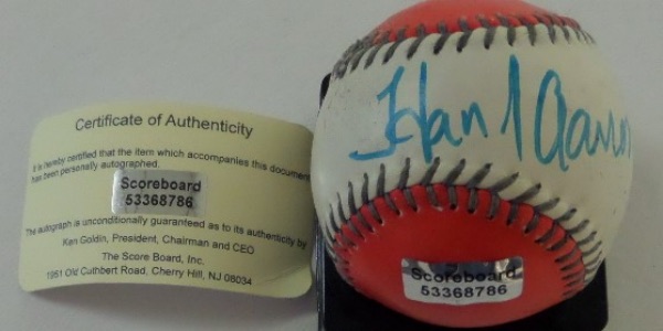 This red and white two tone non official baseball is cubed in VG condition, and comes hand-signed across the sweet spot in blue felt tip marker by all time great and true HR king, Hank Aaron!  The signature is very nice, grading a legible 9, and the ball comes with a COA from Ken Goldin at The Score Board for absolute authenticity.  Valued into the mid/high hundreds!