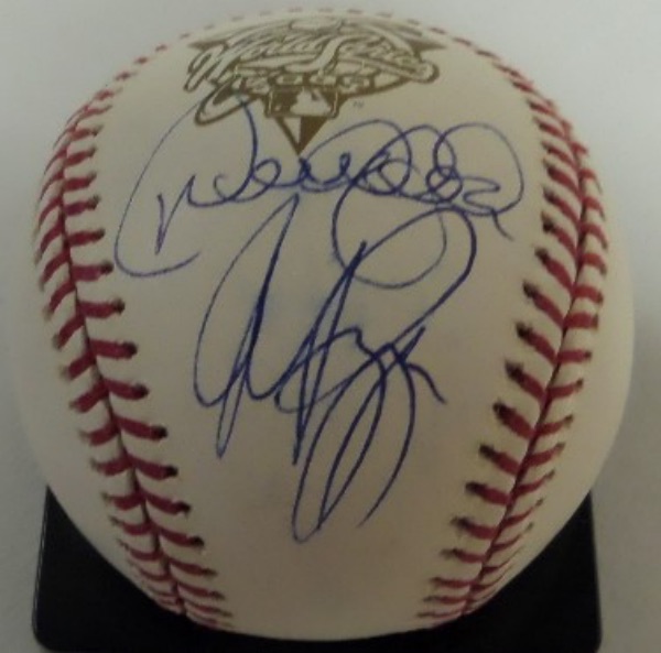 This fantastic and very unique collector's item is an official 2000 World Series baseball from Rawlings--yep, that's the Subway Series between the Mets and Yanks--and this ball is hand-signed by a HOF great from EACH team!  Included are Mets' HOF catcher Mike Piazza, and Yankees' HOF ss, Derek Jeter, BOTH on the same panel, and grading legible 8's or better.  Personally, I've never seen these two all timers on the same ball, unless it was an All Star ball, and this one is affixed with a hologram from All American Collectibles for added authenticity!!!