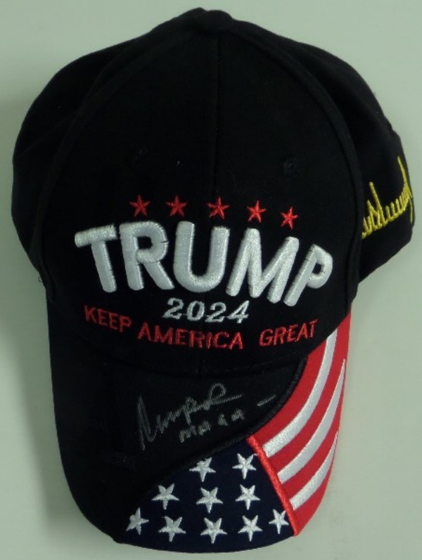 This mostly black Trump 2024 Keep America Great cap is in NM condition, and comes hand-signed on the brim in silver by the President of the United States!  The signature is a legible 8 at least, including a MAGA inscription, and this beautiful cap can easily retail into the low thousands!