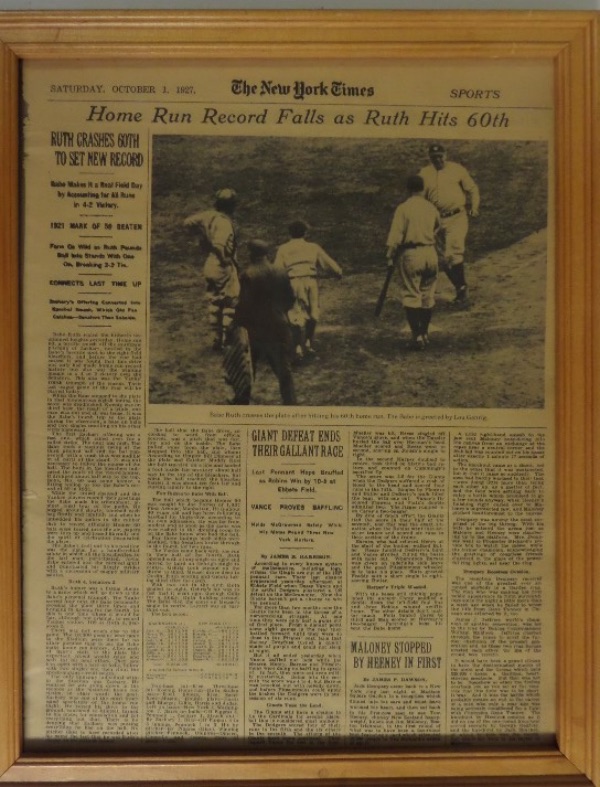 This 12x15 wood frame houses a page from the original Saturday, October 1, 1927 issue of The New York Times.  The page's headline reads, "Home Run Record Falls as Ruth Hits 60th," with an image of the Babe crossing home plate and shaking hands with Lou Gehrig, also including an article and box score.  Nothing to do here but hang and admire, and this one is ideal for ANY baseball collection!